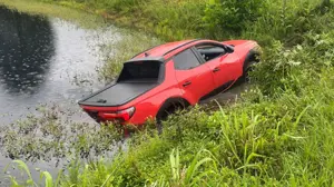 Man arrested after crashing car into pond