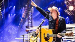 Morgan Wallen fan goes viral kicking a phone out of someone's hand as she's being escorted out in handcuffs