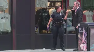 Knife-wielding woman accused of stabbing 2 in Times Square before being shot by police