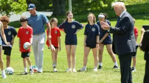 Pat McAfee attends sporting event with President Trump wearing jeans and a backwards cap