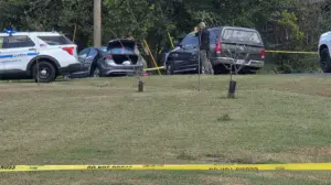 Police fatally shoot sword-wielding man after woman found trapped in car, officials say